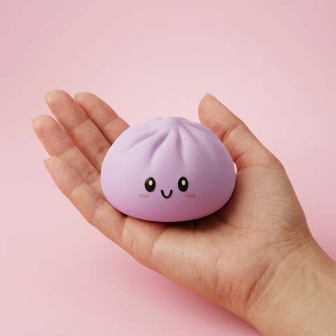 Dumpling Squishy Magenta i handen, verklig storlek